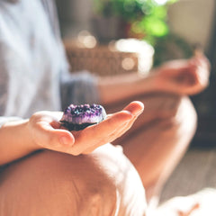 Meditating with an amethyst crystal