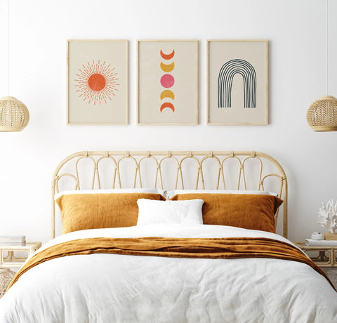 A bedroom with 3 geometric boho style artworks on the wall