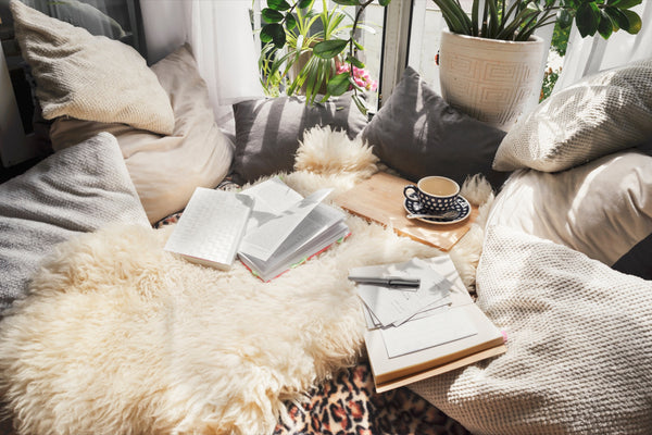 Hygge boho vibe lounge with blankets, cushions and sheepskins