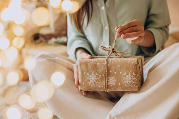 A lady unwraps a beautiful handmade gift on Christmas morning