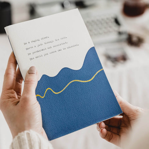 A hand painted and typed blue and gold journal gift