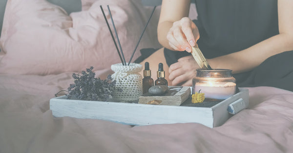 A woman lights incenses and candles in a new year ritual