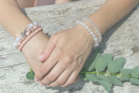 A lady wearing healing crystal quartz bead bracelets