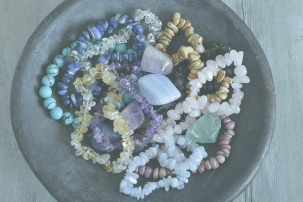 A bowl of healing crystal bead bracelets to select the energies you need to support you