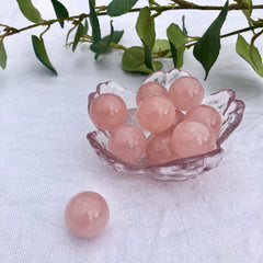 Rose Quartz crystal spheres in a small pink flower trinket dish