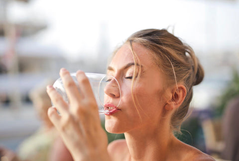 Woman drinking tap water from a glass