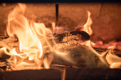 Man burning wood in a stove