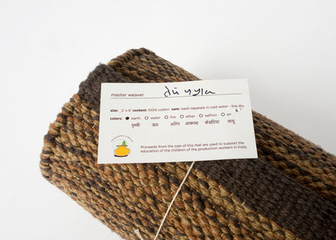 Organic cotton brown yoga rug with weaver's signature card