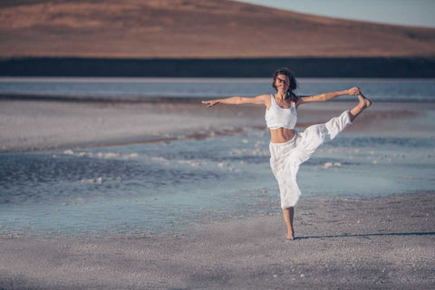 Woman doing yoga pose on the beach