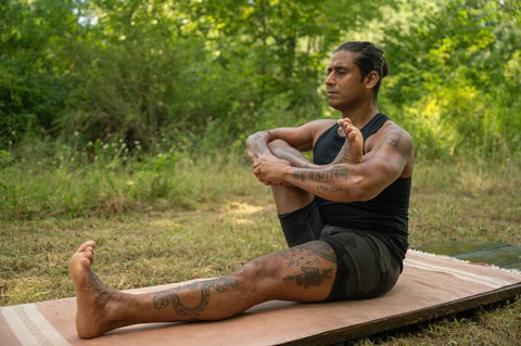 Jai Sugrim in a yoga pose on a yoga mat