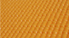 Closeup of an orange colored sticky mat.