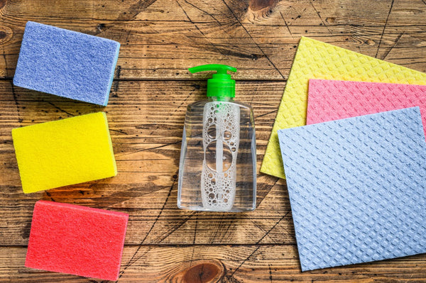 Cleaning supplies including spray bottle, rags and sponges