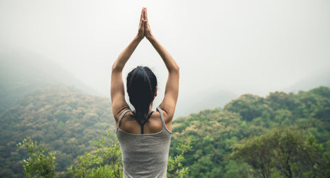 yoga meditation pose overlooking mountains