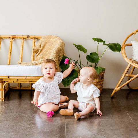 Babies playing whilst wearing reusable cloth nappies made in Australia