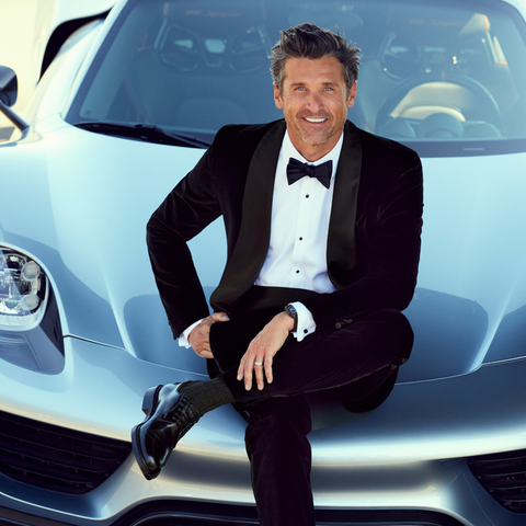 Patrick Dempsey sitting on Porsche