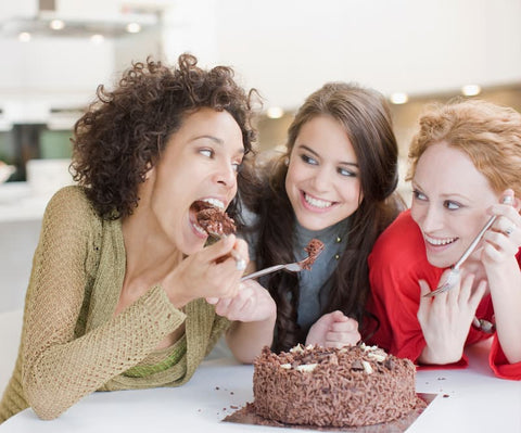 friends enjoying a chocolate cake together