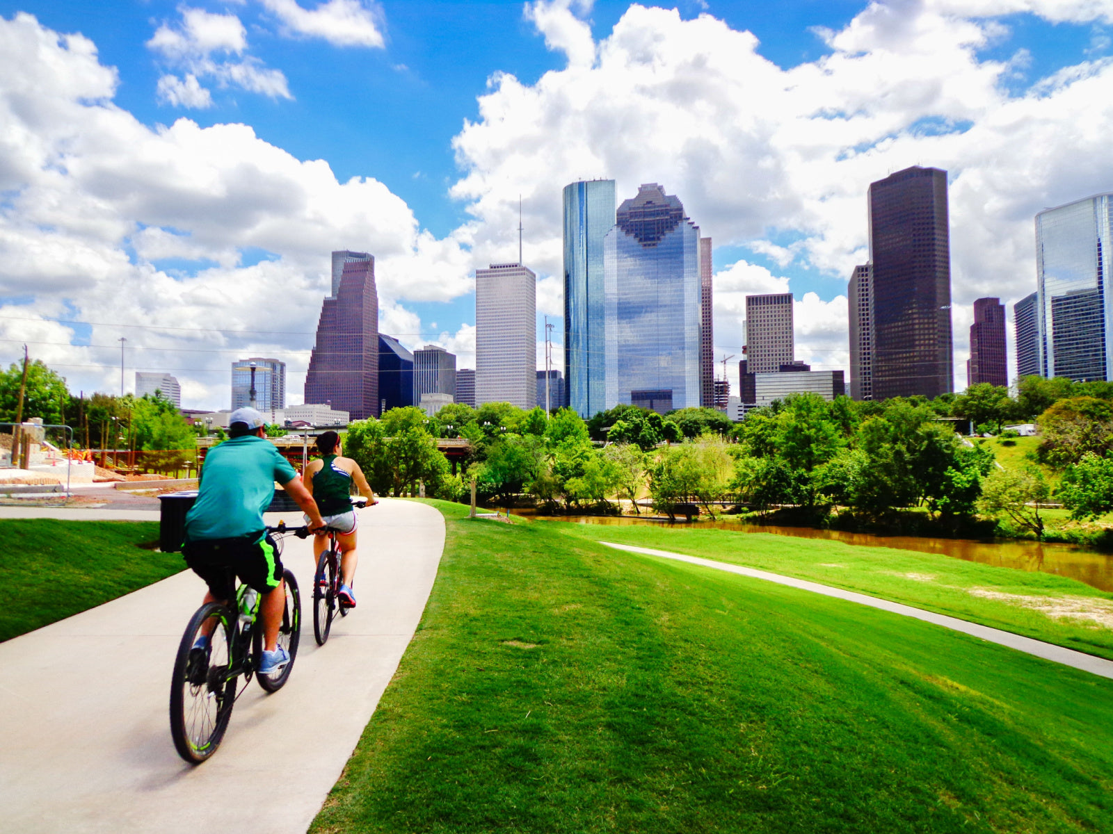 cyclists on path going toward Houston TX skyline, office furniture Nationwide cubicles