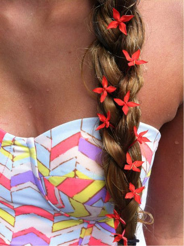 braided hair with red flowers