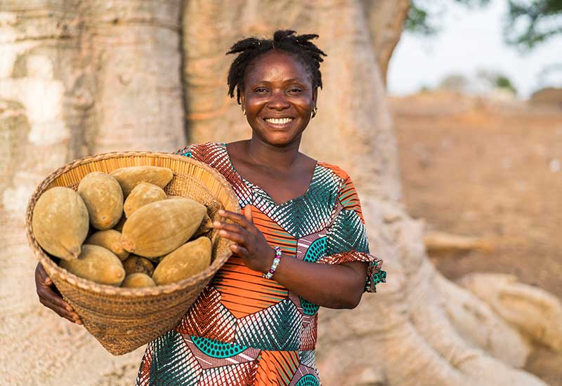 Aduna Baobab Producer, Lardi, with basket of fruits