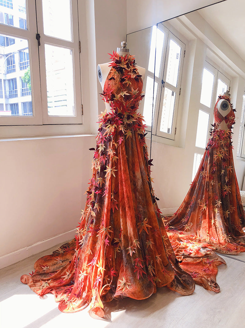 Orange halter neck gown with autumn leaves embellishment