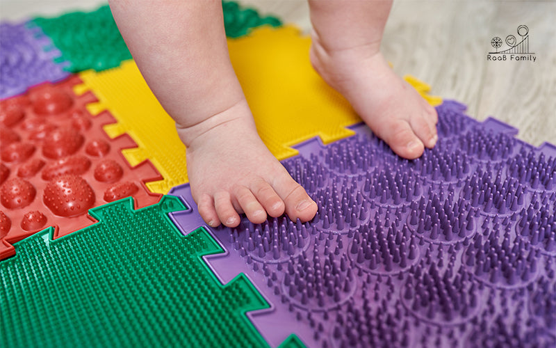 Child's Feet Standing On Soft Baby Play Mat