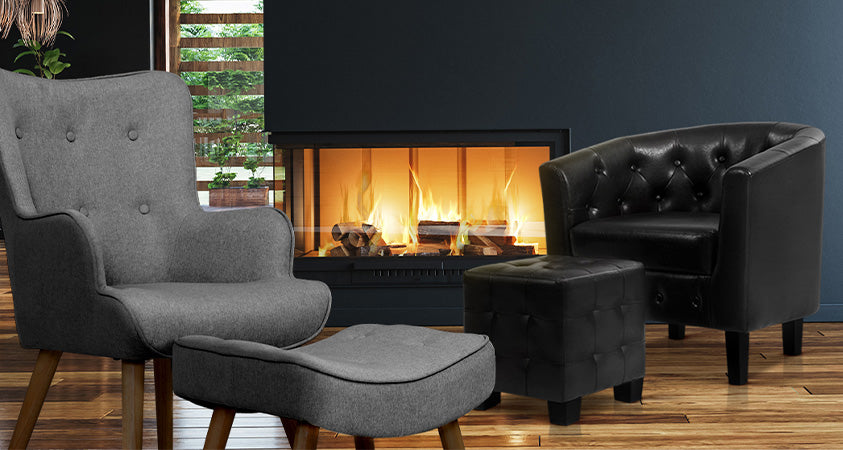 The Artiss Lansar and Ava armchair and ottoman sets are positioned near a fireplace. They add a sophisticated touch to this incredibly dark bold room. 