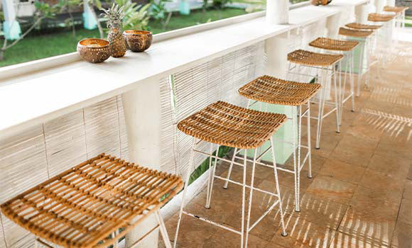 An outdoor set-up featuring gorgeous wicker rattan bar stools creates a dreamy ambience. 