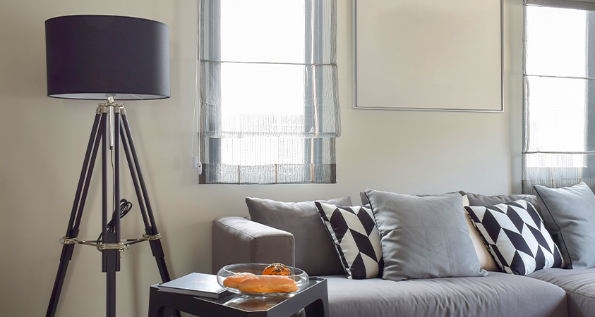 Flaunting eye-catching accents, this gorgeous black lampshade tripod floor lamp dims the light to create a warm and cosy ambience that perfectly matches this room's interior.   