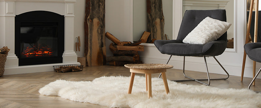 The ivory-coloured faux fur area rug adds a cosy touch to this fireplace reading nook, creating a dreamy spot where you could read in forever. 