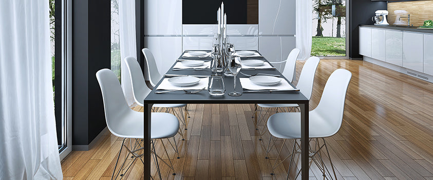 This matt-black metal dining table with clean, smooth lines and white curved dining chairs fuses modern and industrial styles that perfectly complement this modern contemporary dining room.   