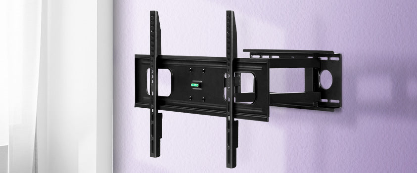 An Artiss full motion wall mount bracket with a spirit level, installed on a plaster wall.