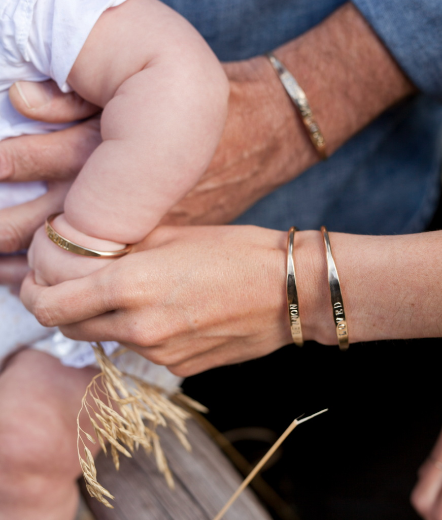 Close up on a family with wearing custom word bracelets