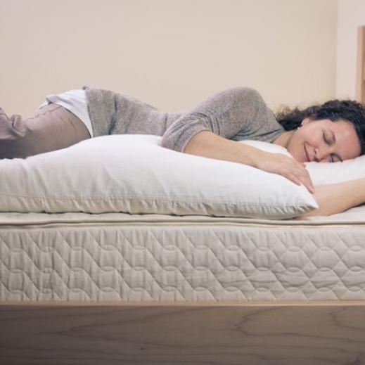 Woman sleeping on an organic body pillow form Savvy Rest