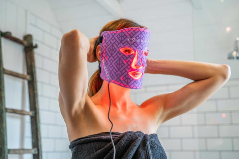 Woman in her bathroom wearing the Koanna Infrared Mask