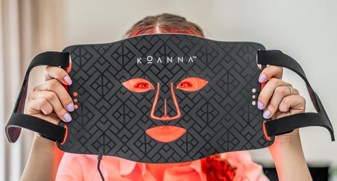 Woman putting on the Koanna LED Mask