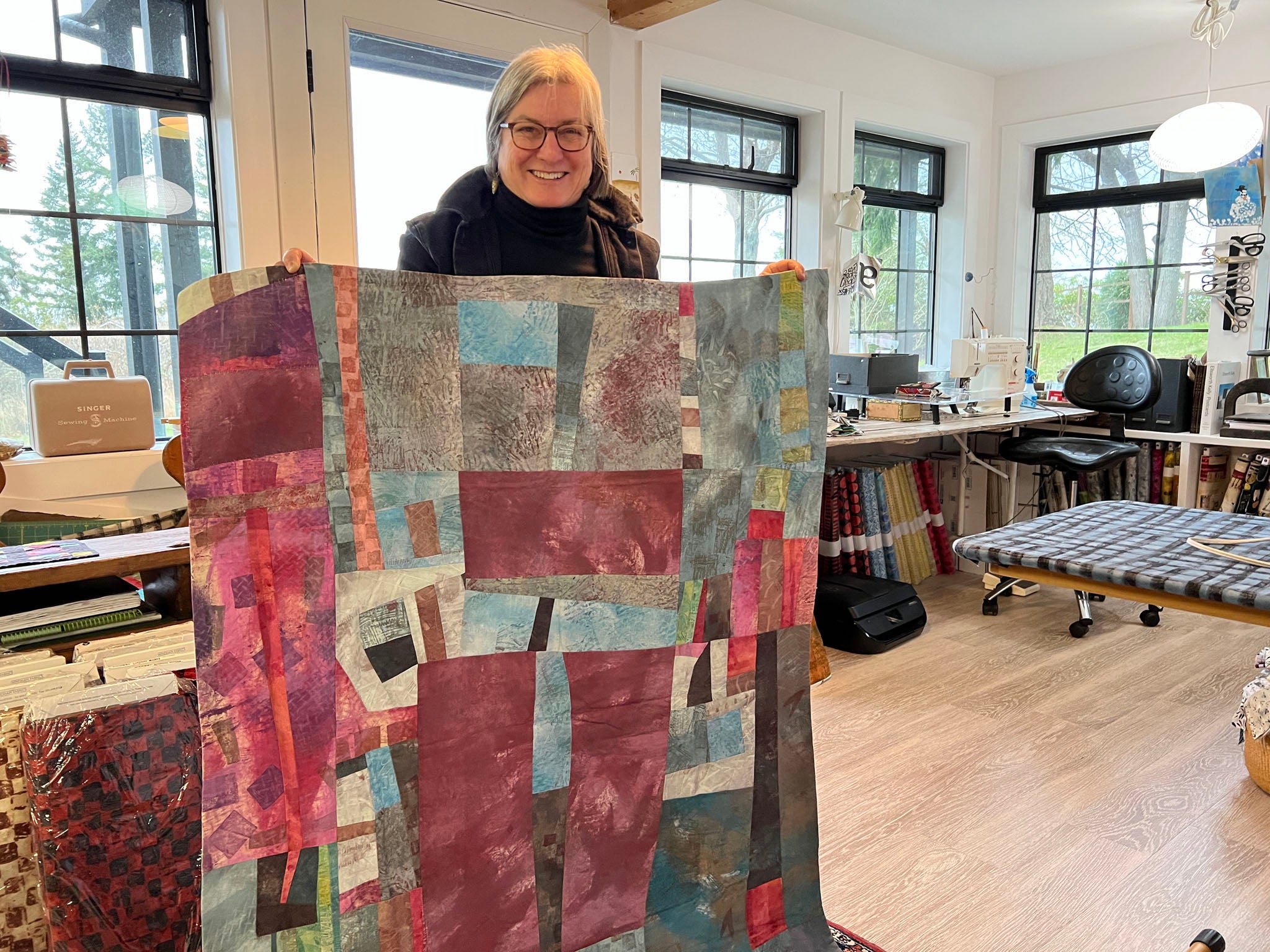 Fabric designer Marcia Derse in her studio with an early quilt project