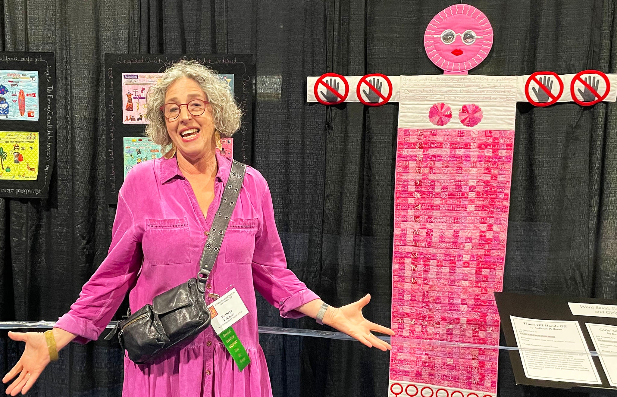 Long Beach Quilt Festival 2023 - Kathryn Pellman in front of her piece Times Off Hands Off - Photo By Victoria Stone