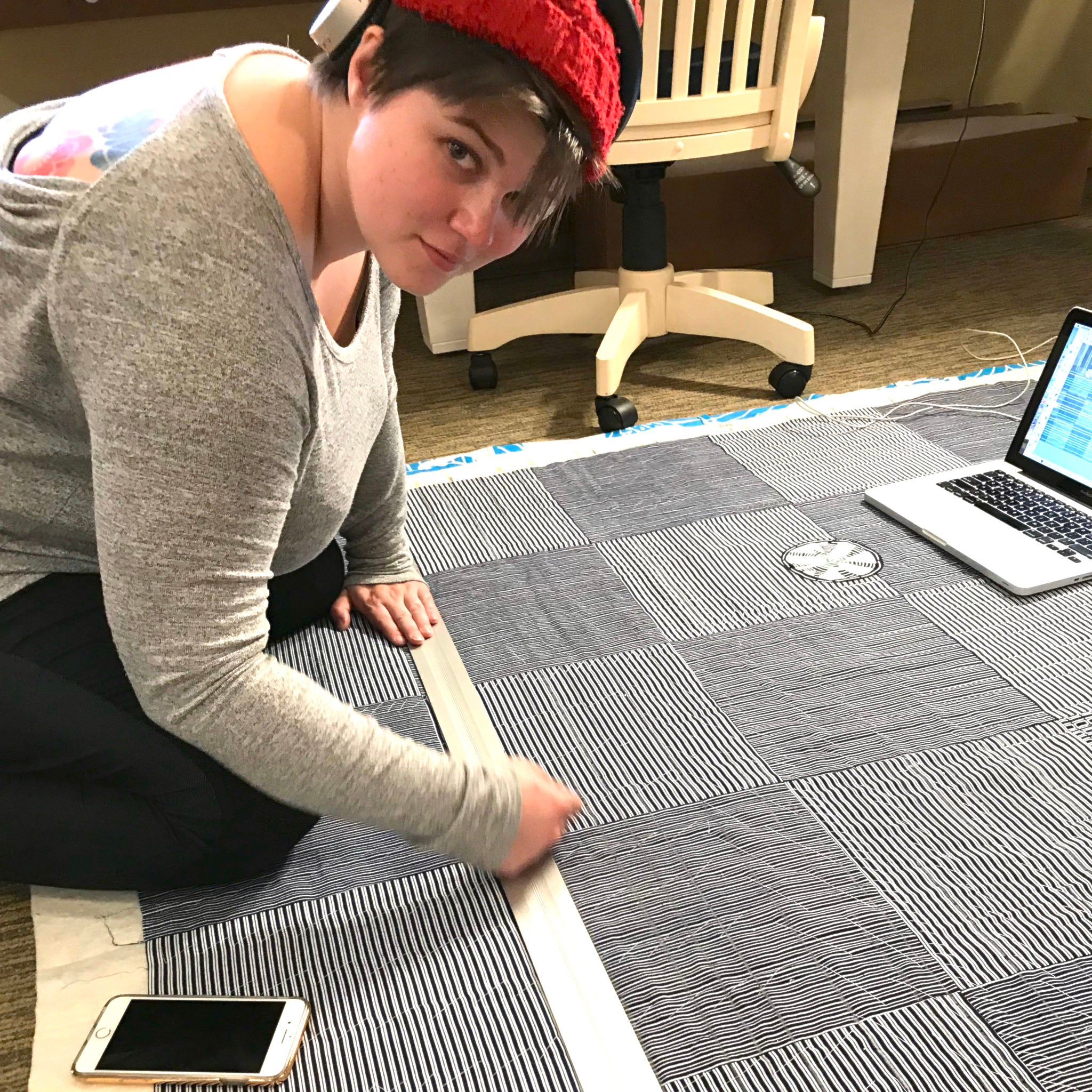 Victoria Stone of Okan Arts marking Boro Quilt with stitch lines for the Sashiko 2 sewing machine