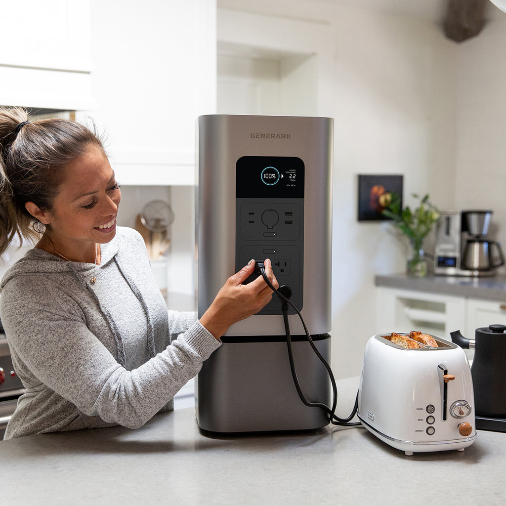 A woman plugs a toaster into the HomePower 2 portable power station for modern homes.