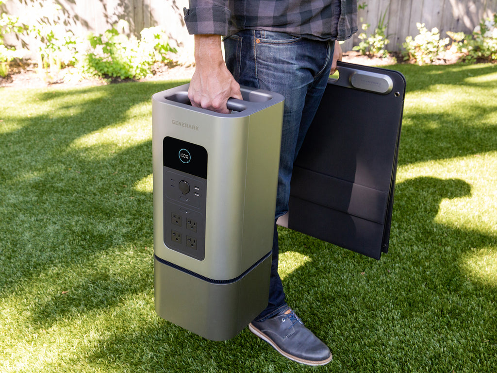 A man carries the Generark Solar Generator with the built-in ergonomic handle.