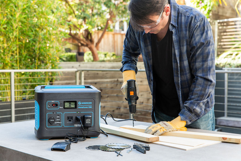 A man uses a power drill that is powered by the HomePower ONE portable power station.