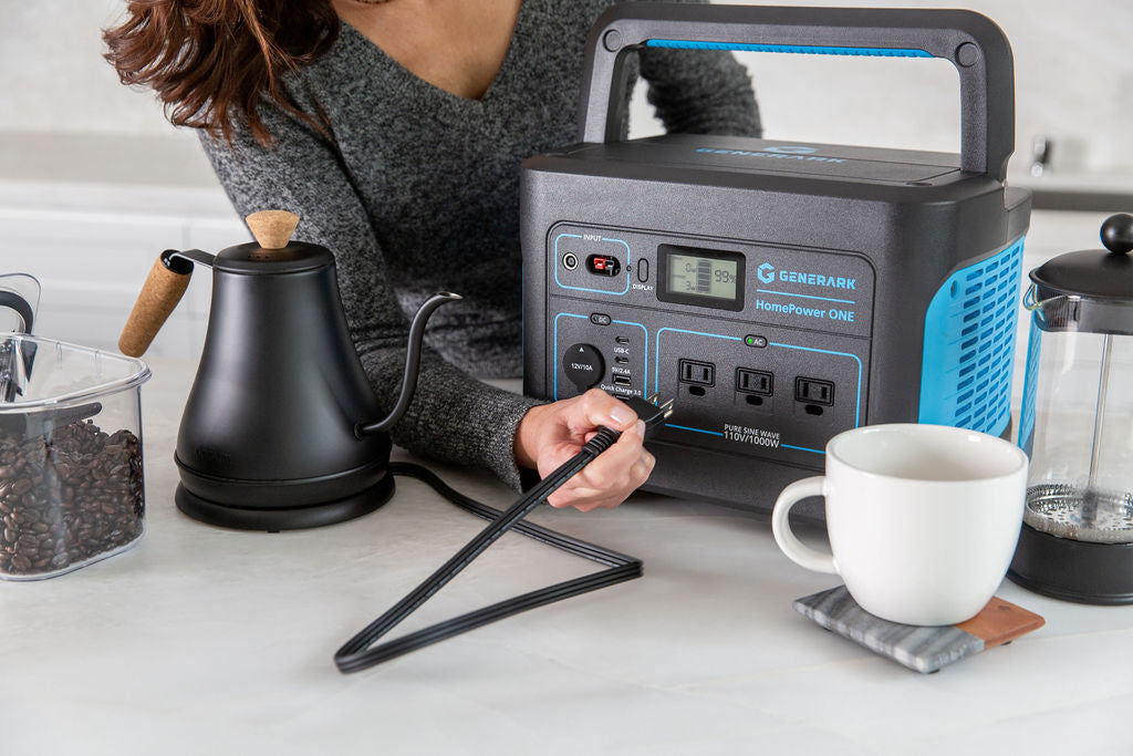 A woman plugs a kettle into the HomePower ONE portable power station.