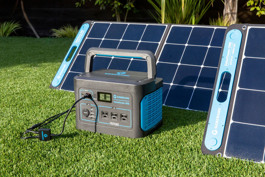 The HomePower ONE backup battery generator and SolarPower ONE solar panel power station are pictured on an outdoor lawn.