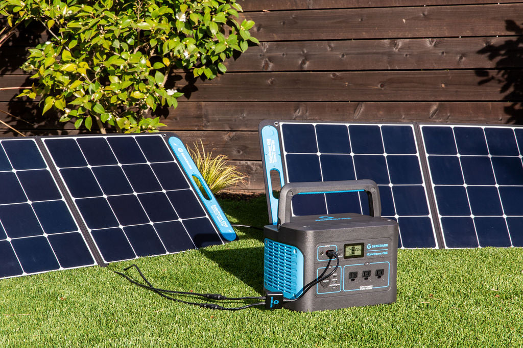 The HomePower ONE backup battery power station and SolarPower ONE solar panel power station are pictured on a lawn.