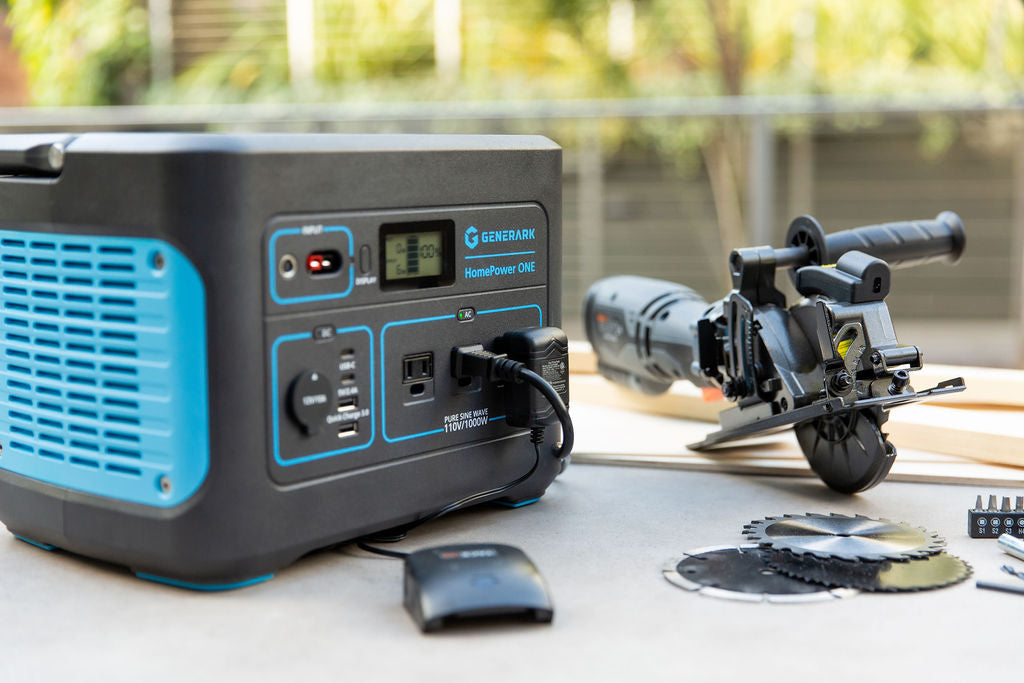 The HomePower ONE is pictured on an outdoor workbench powering a saw.