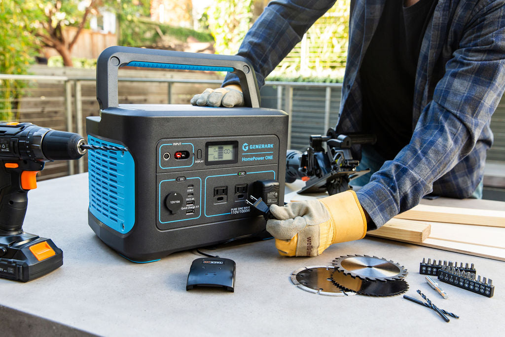 A man plugs a power tool into the HomePower ONE portable power station.