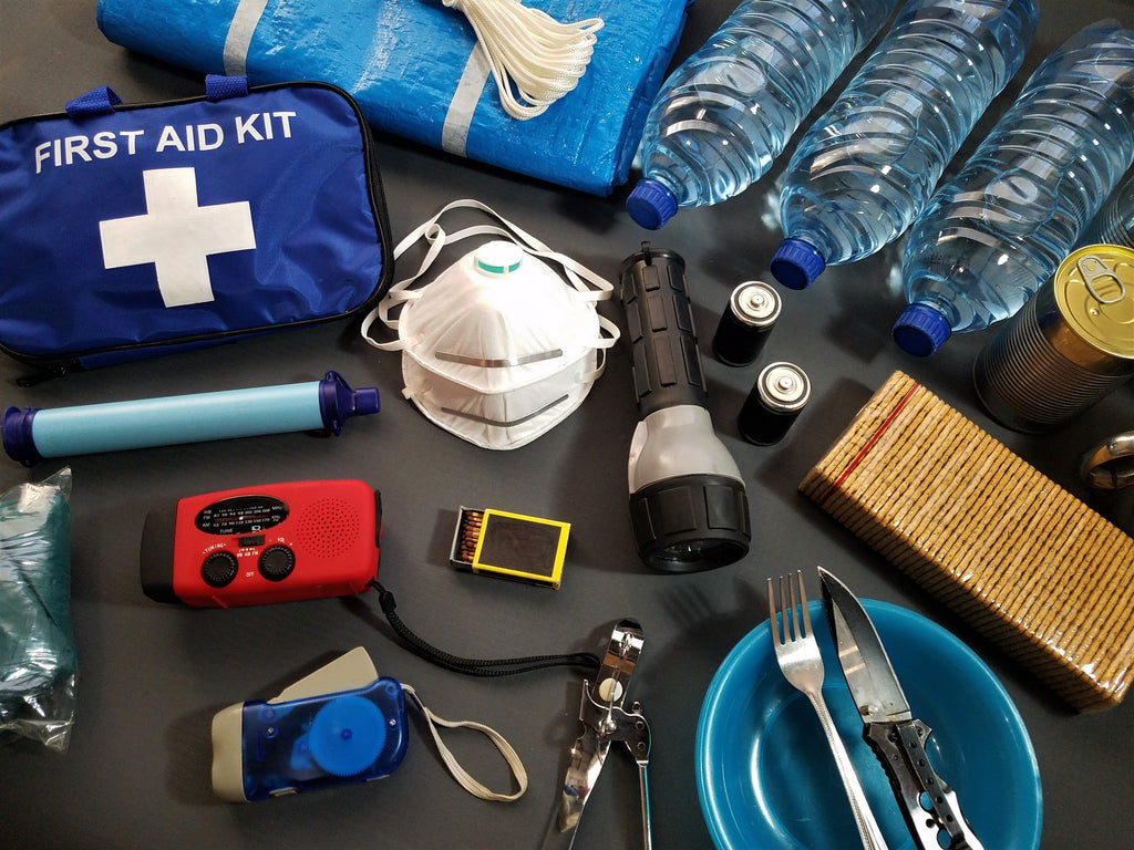 An emergency supply kit shows a mask, water, utensils, flashlight, and first aid kit.