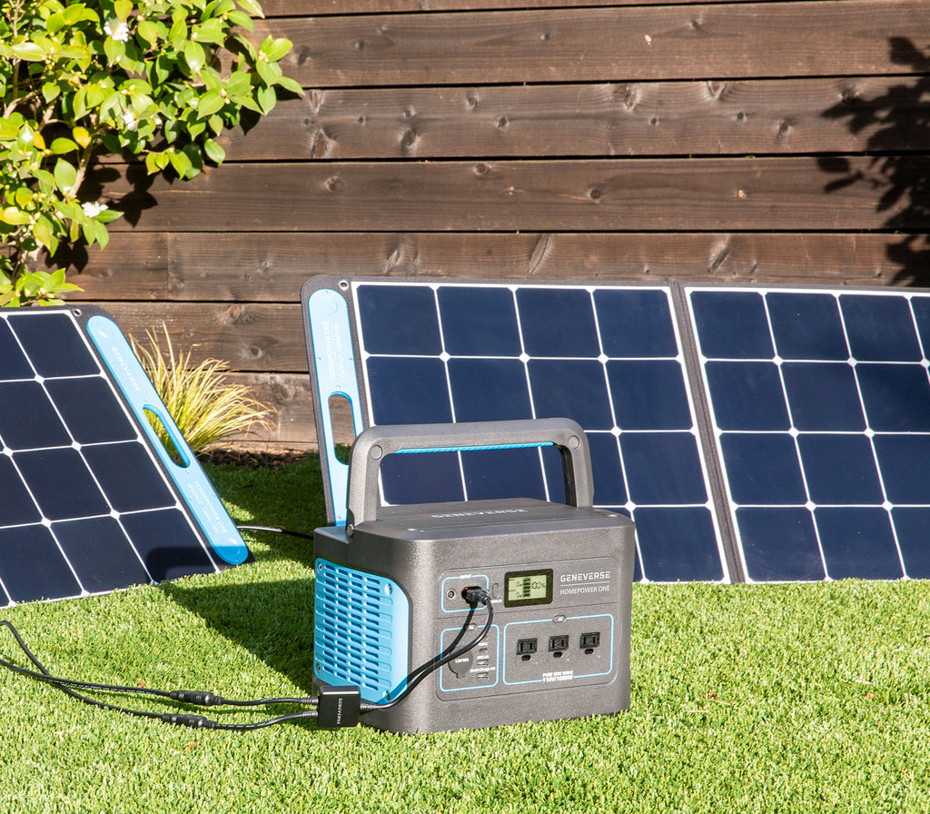 The HomePower ONE backup battery generator and SolarPower ONE solar panel power station are pictured on an outdoor lawn.