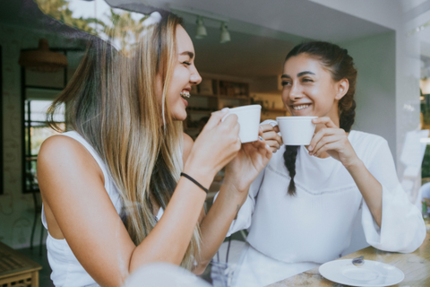 People enjoying coffee in a cafe window.