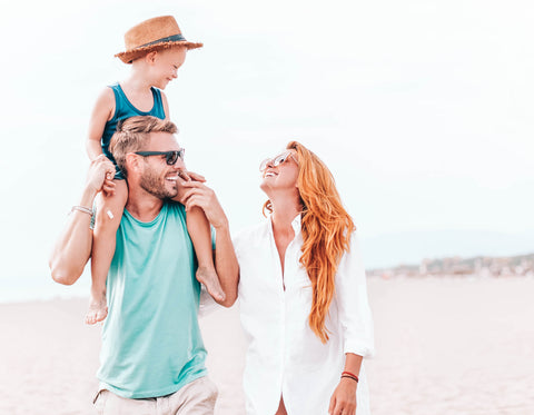 Mom and Dad Walking on Beach with Toddler on Dad's Shoulders